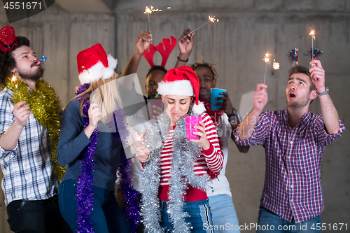 Image of multiethnic group of casual business people dancing with sparkle