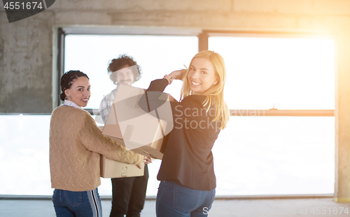 Image of business team carrying cardboard boxes