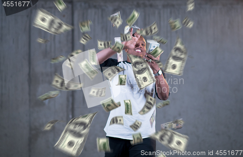 Image of black businessman making the rain of money