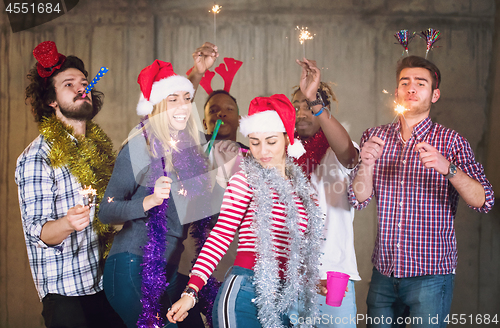 Image of multiethnic group of casual business people dancing with sparkle