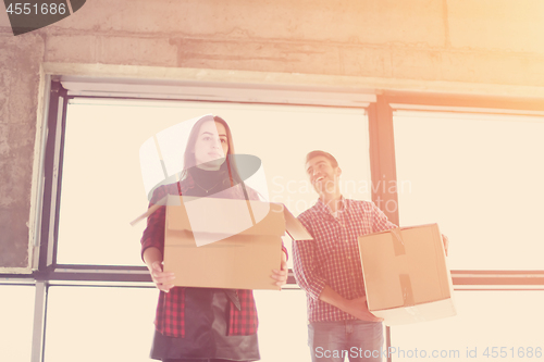 Image of business team carrying cardboard boxes