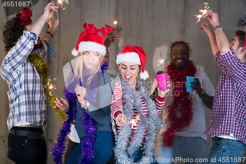 Image of multiethnic group of casual business people dancing with sparkle