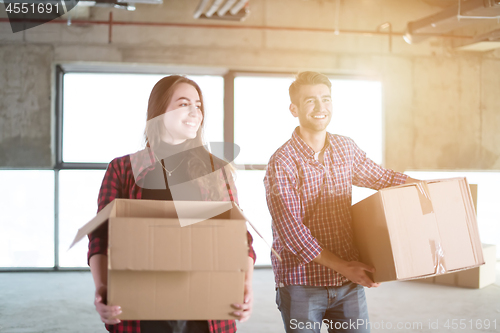 Image of business team carrying cardboard boxes