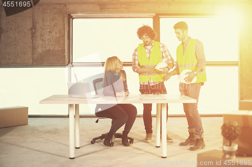 Image of business people in group on construction site