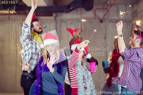 Image of multiethnic group of casual business people dancing with sparkle