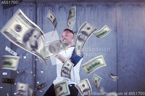 Image of black businessman making the rain of money