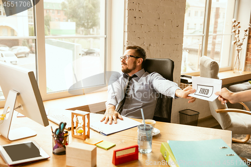 Image of Young businessman fired, looks upset