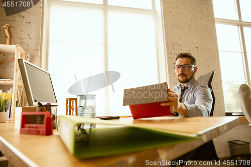 Image of A young businessman working in office after promotion