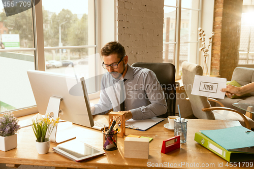 Image of Young businessman fired, looks upset