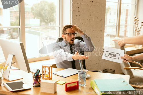 Image of Young businessman fired, looks upset