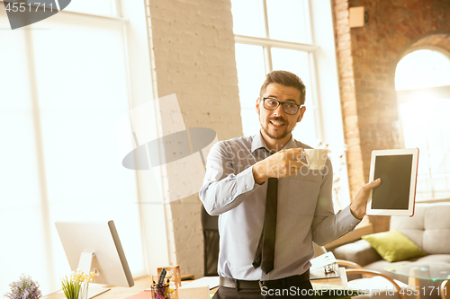 Image of A young businessman working in office after promotion