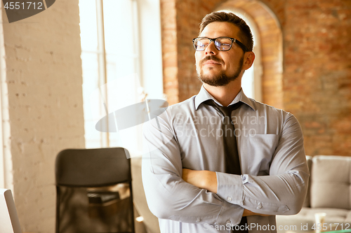 Image of A young businessman working in office after promotion