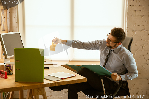Image of A young businessman working in office after promotion