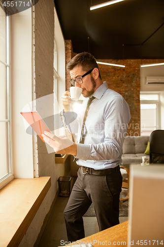 Image of A young businessman working in office after promotion