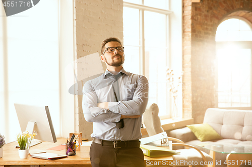 Image of A young businessman working in office after promotion