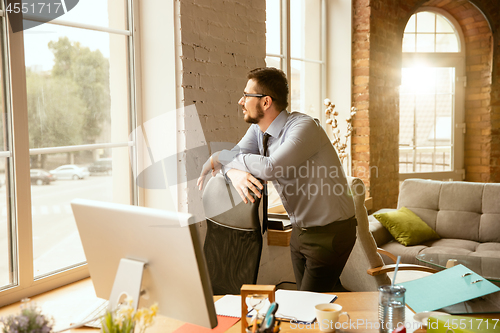 Image of A young businessman working in office after promotion