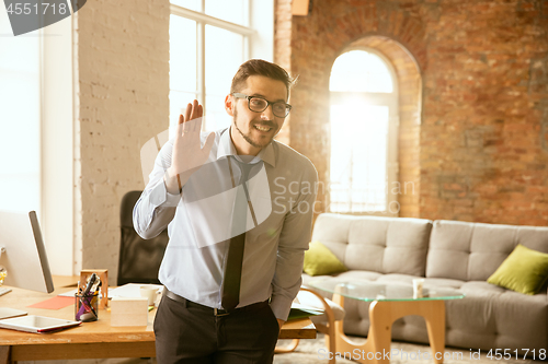 Image of A young businessman working in office after promotion