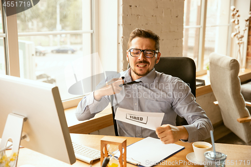 Image of Young businessman fired, looks upset