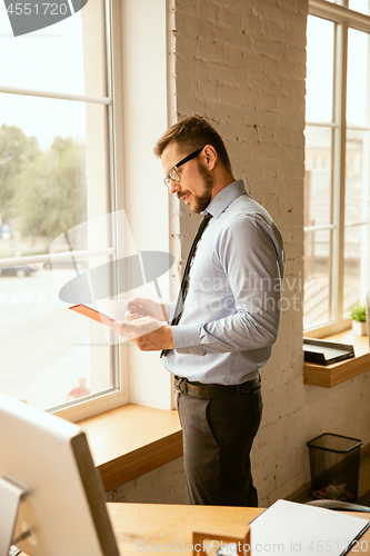 Image of A young businessman working in office after promotion