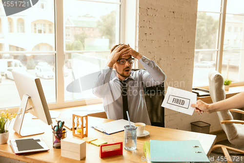 Image of Young businessman fired, looks upset