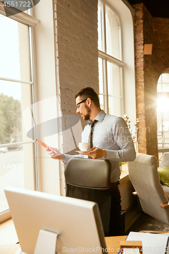 Image of A young businessman working in office after promotion