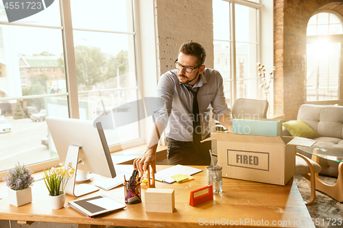 Image of Young businessman fired, looks upset