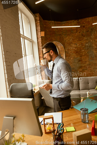 Image of A young businessman working in office after promotion