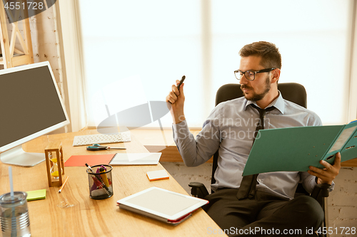 Image of A young businessman working in office after promotion