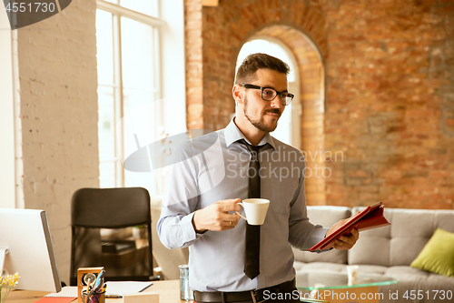 Image of A young businessman working in office after promotion