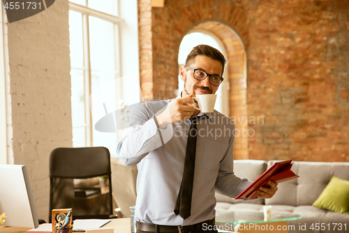 Image of A young businessman working in office after promotion