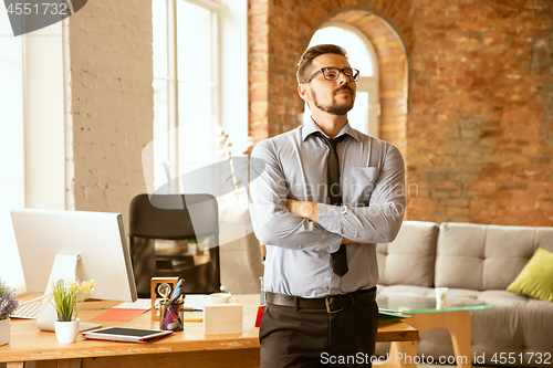 Image of A young businessman working in office after promotion