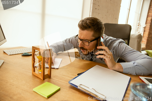 Image of A young businessman working in office after promotion