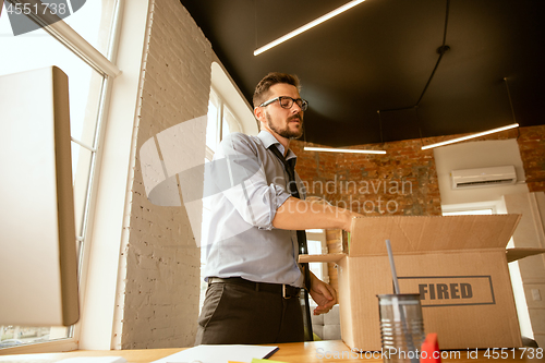 Image of Young businessman fired, looks upset