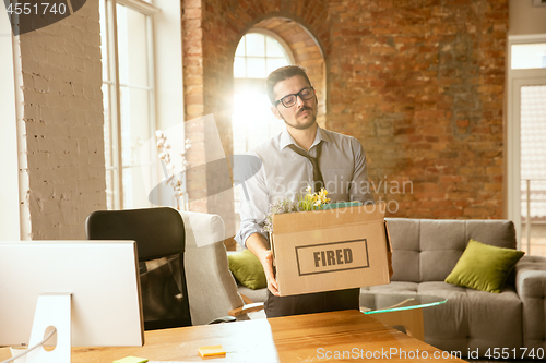 Image of Young businessman fired, looks upset