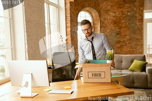 Image of Young businessman fired, looks upset