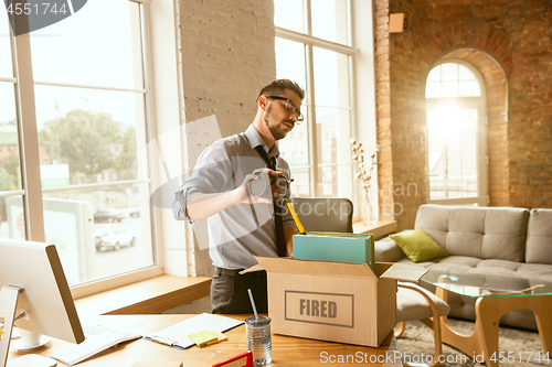 Image of Young businessman fired, looks upset