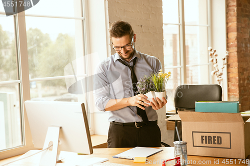 Image of Young businessman fired, looks upset