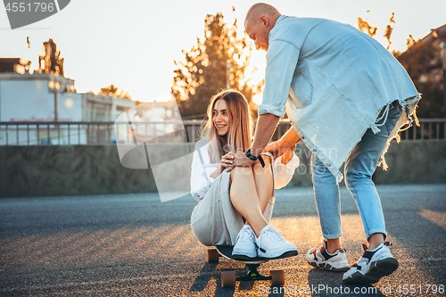 Image of Tanned young caucasian couple, modern lovestory in film grain effect