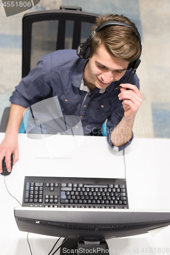 Image of male call centre operator doing his job top view