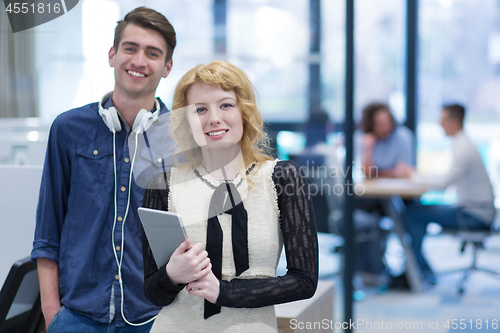 Image of Business People Working With Tablet in startup office