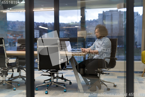 Image of Young casual businessman using smartphone