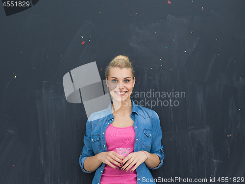 Image of woman blowing confetti in the air isolated over gray