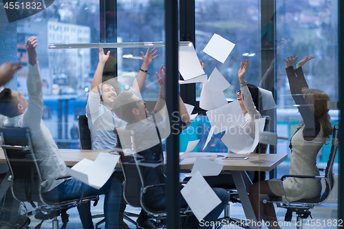 Image of startup Group of young business people throwing documents