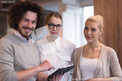 Image of Business People Working With Tablet in startup office