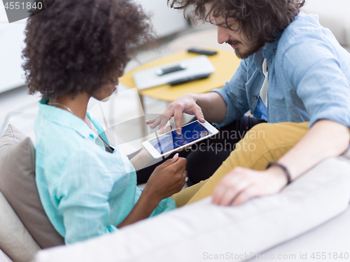 Image of multiethnic couple in living room