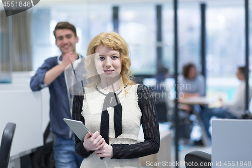 Image of Business People Working With Tablet in startup office