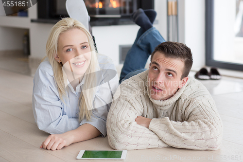 Image of Young Couple using digital tablet on cold winter day