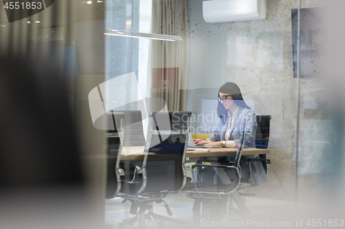 Image of businesswoman using a laptop in startup office