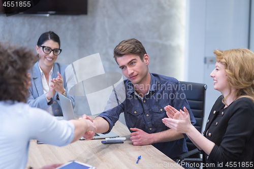 Image of cloasing the deal in modern office interior