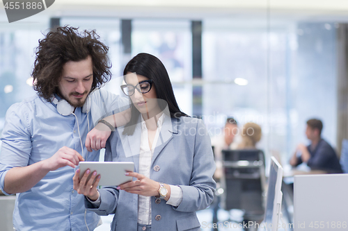 Image of Business People Working With Tablet in startup office